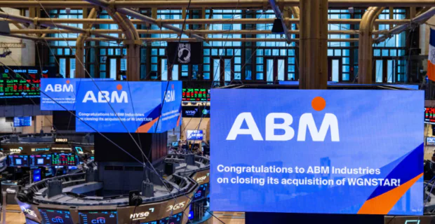 Screens on the floor of the New York Stock Exchange Celebrating the Acquisition of WGNSTAR by ABM