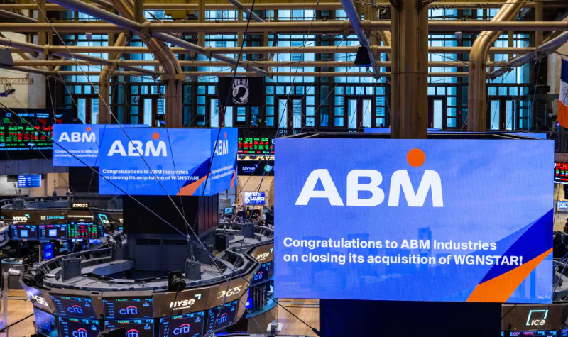 Screens on the floor of the New York Stock Exchange Celebrating the Acquisition of WGNSTAR by ABM
